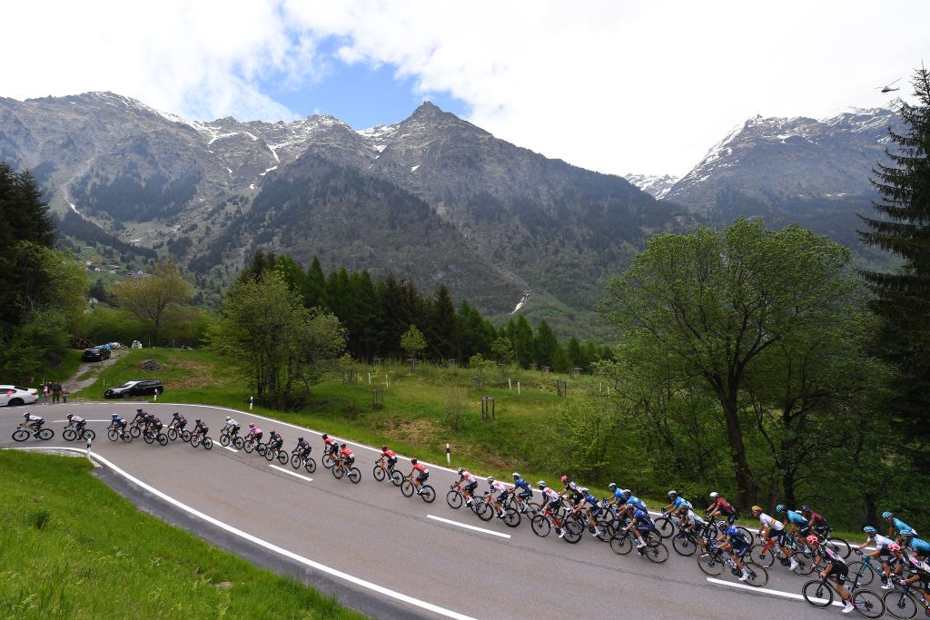 VALLE SPLUGA ALPE MOTTA ITALY MAY 29 Egan Arley Bernal Gomez of Colombia and Team INEOS Grenadiers Pink Leader Jersey The peloton passing through Mesocco mountains 792m landscape during the 104th Giro dItalia 2021 Stage 20 a 164km stage from Verbania to Valle Spluga Alpe Motta 1727m Snow Alps Switzerland CHE UCIworldtour girodiitalia Giro on May 29 2021 in Valle Spluga Alpe Motta Italy Photo by Tim de WaeleGetty Images