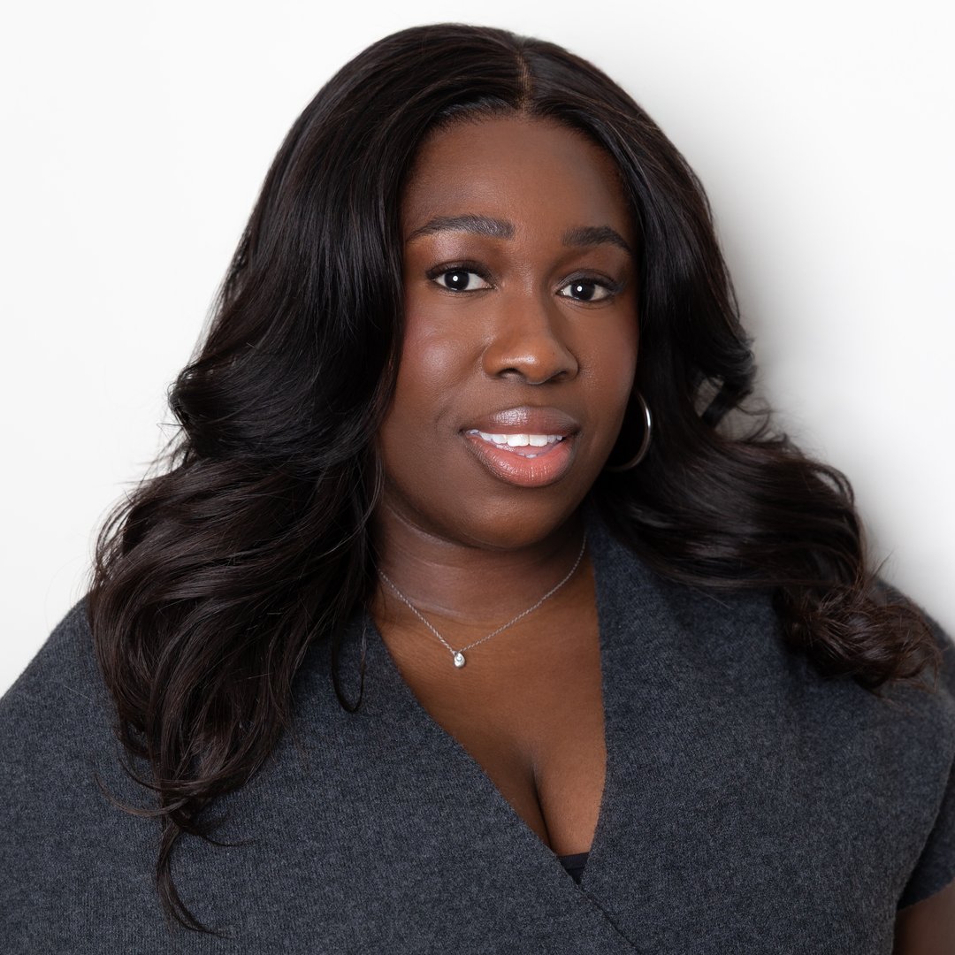 a headshot of a black woman with long, dark hair