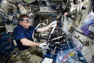 Virts Performs Microgravity Experiment