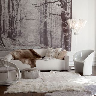 white room with leather sofa and animal skin rugs