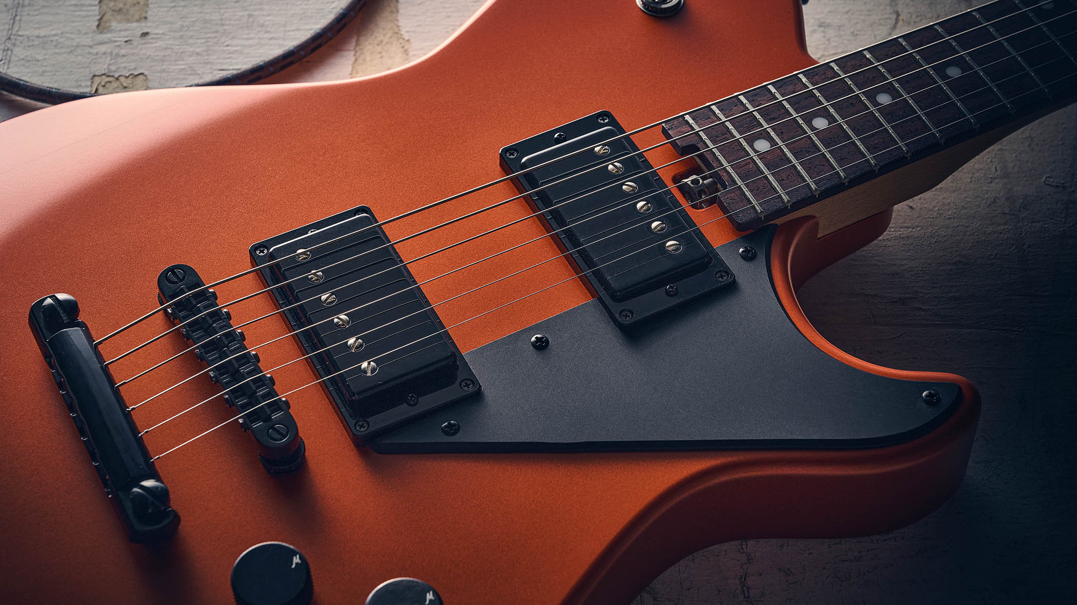 Manson MD-3 Mikey Demus Signature: the hot-orange T-style is photographed against a distressed grey-white background