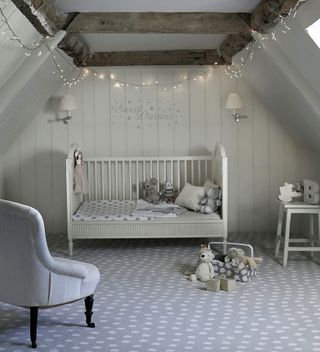 Nursery ideas in a gray attic bedroom by Carpetright, with spotted carpet and string lights.