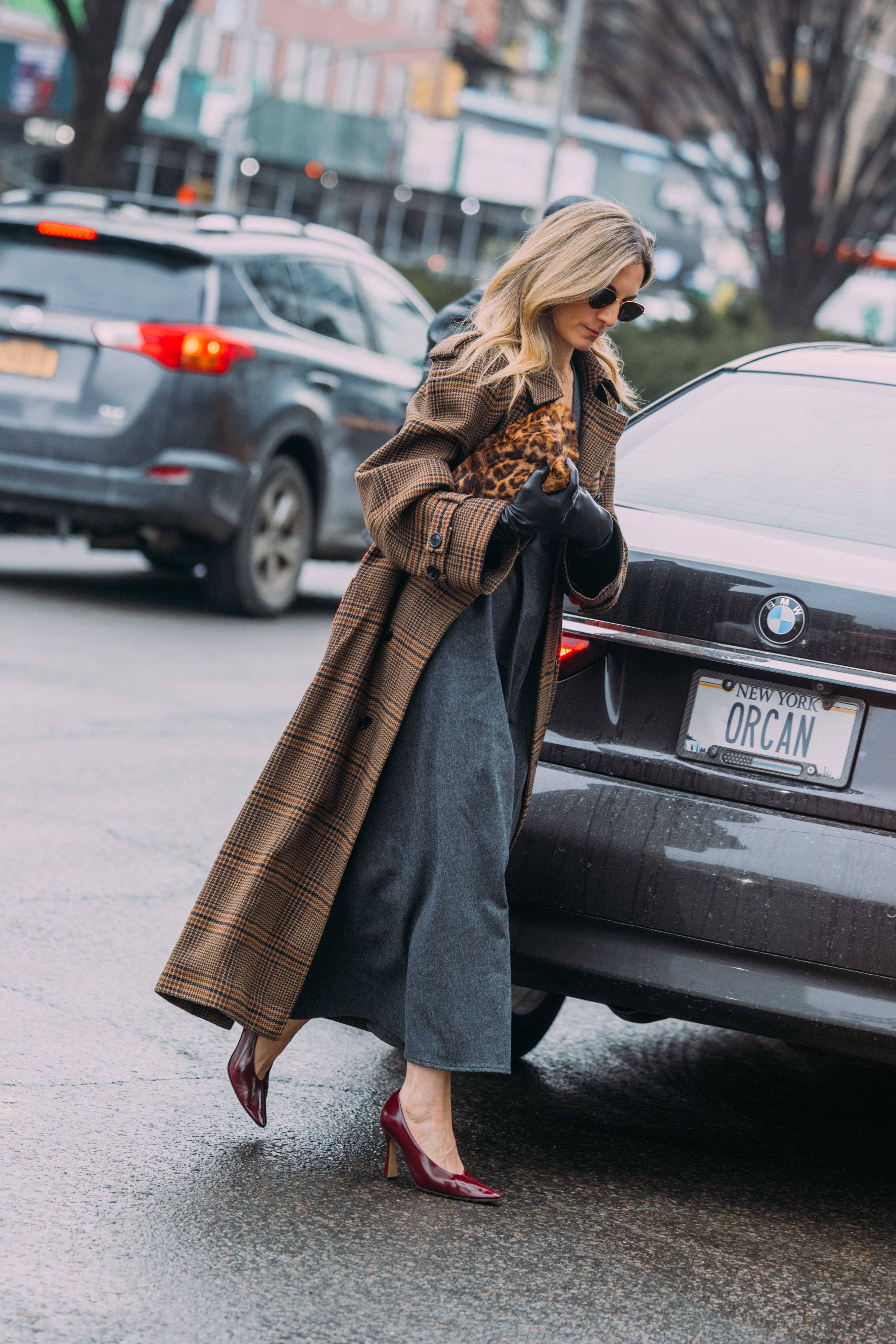 a woman wears a printed jacket during fashion week.