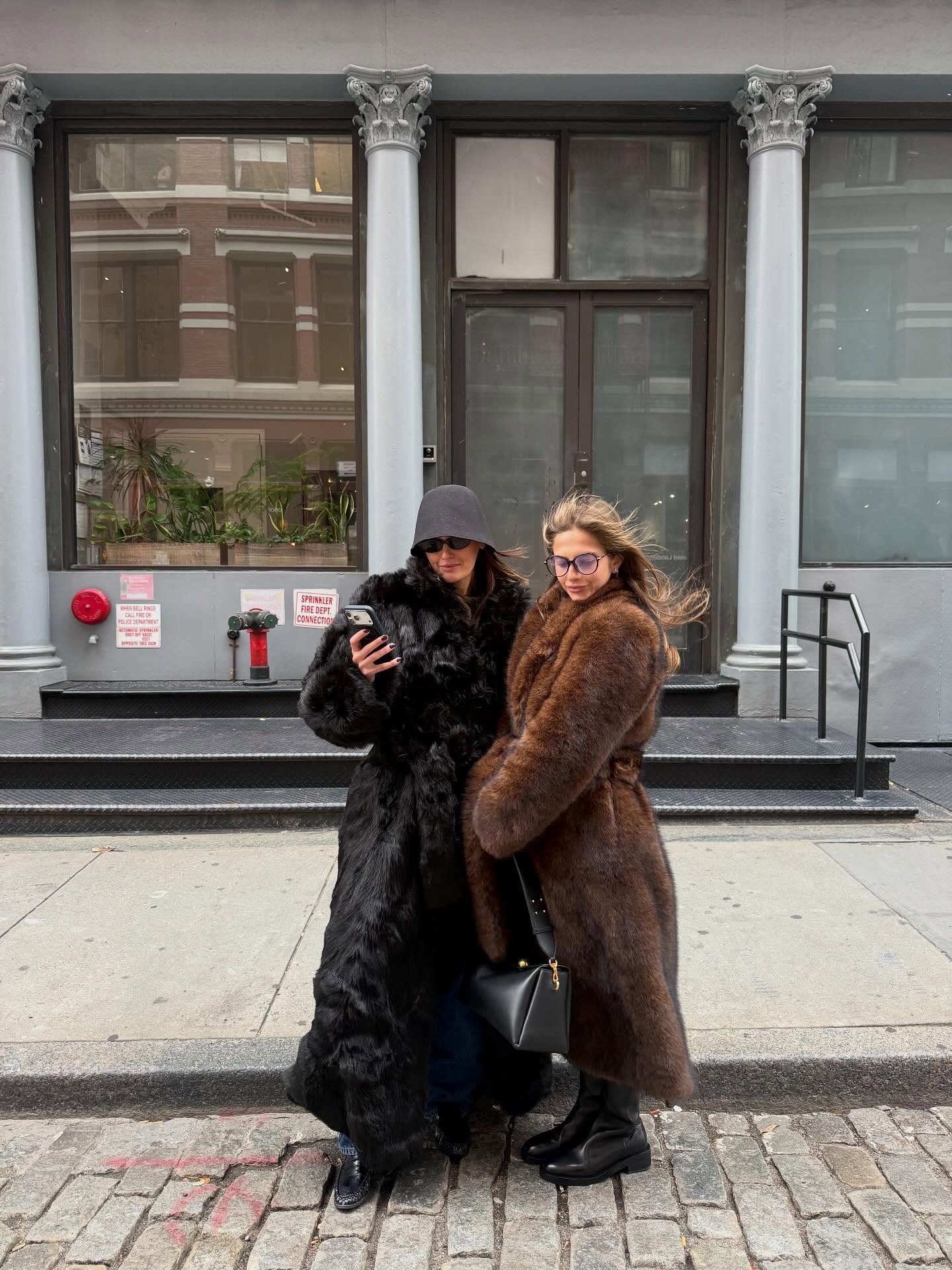 Influencer @cocoschiffer wears a belted fur coat with a knitted bucket hat.