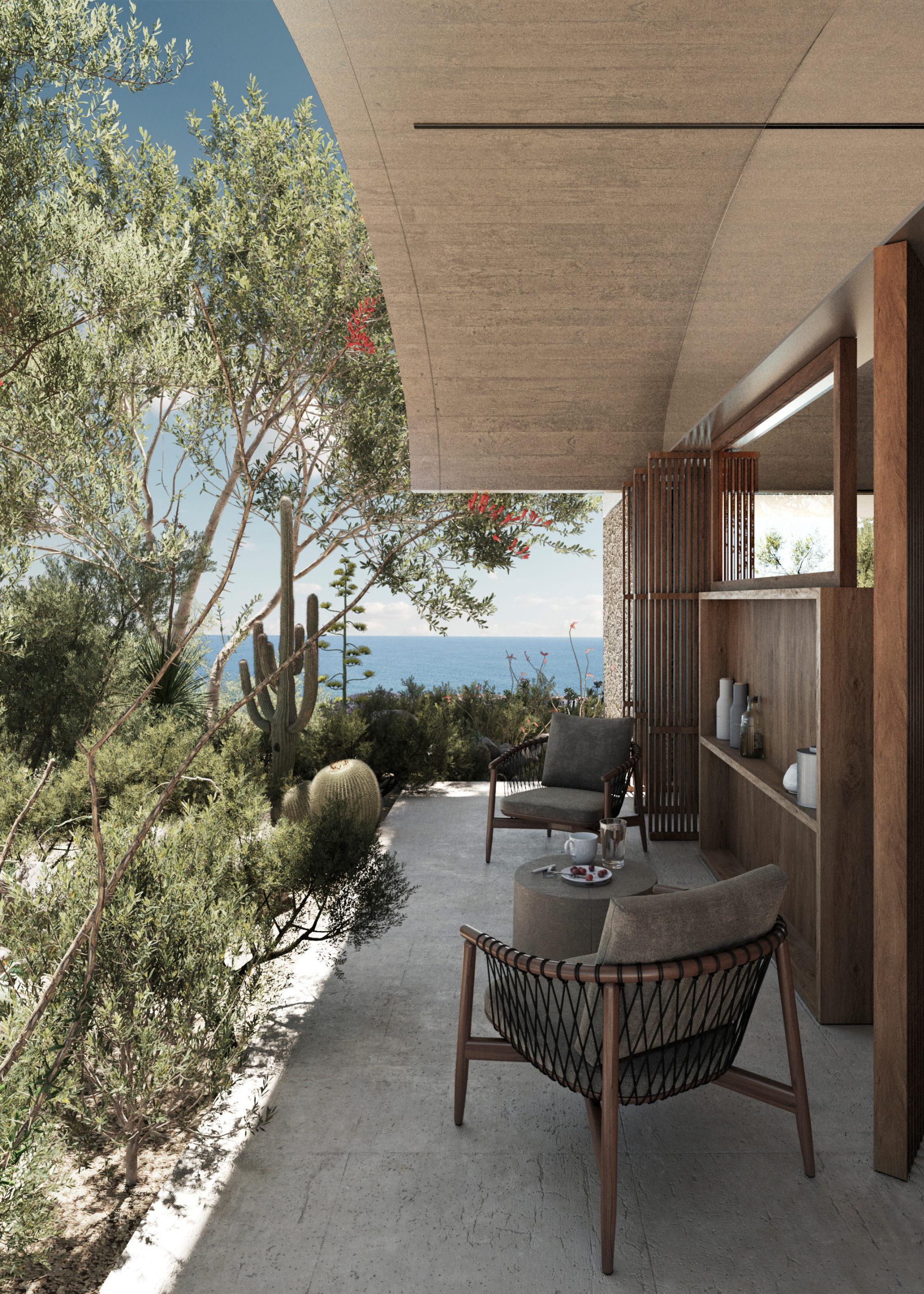 An outdoor seating nook by a layered garden with cactus, grass and trees