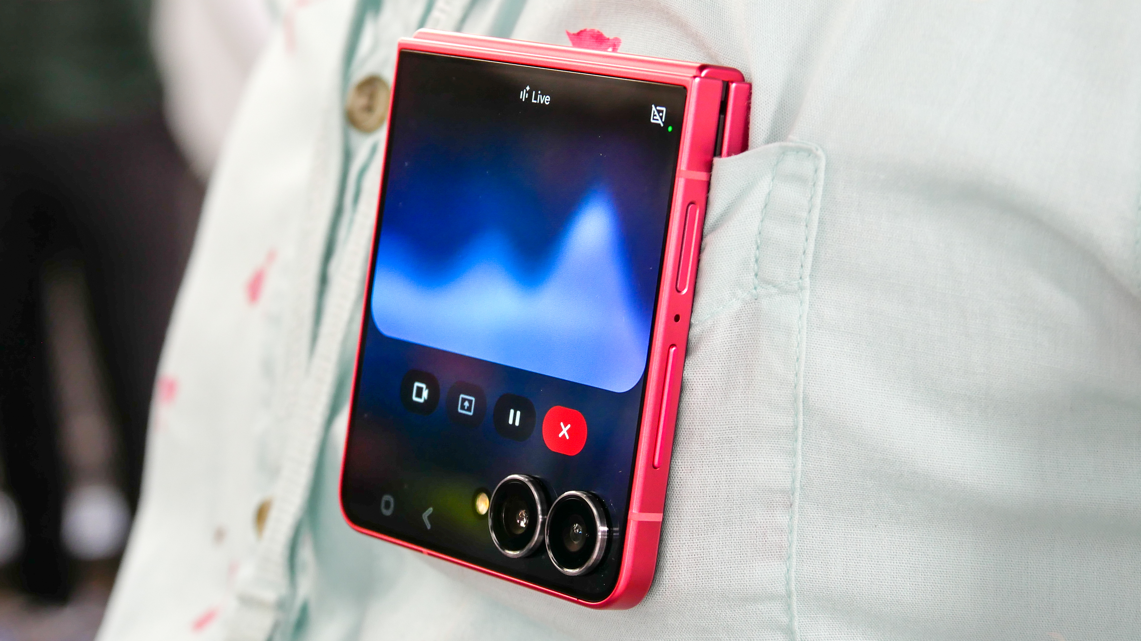 Samsung Galaxy Z Flip 7 in a shirt pocket running Gemini Live.