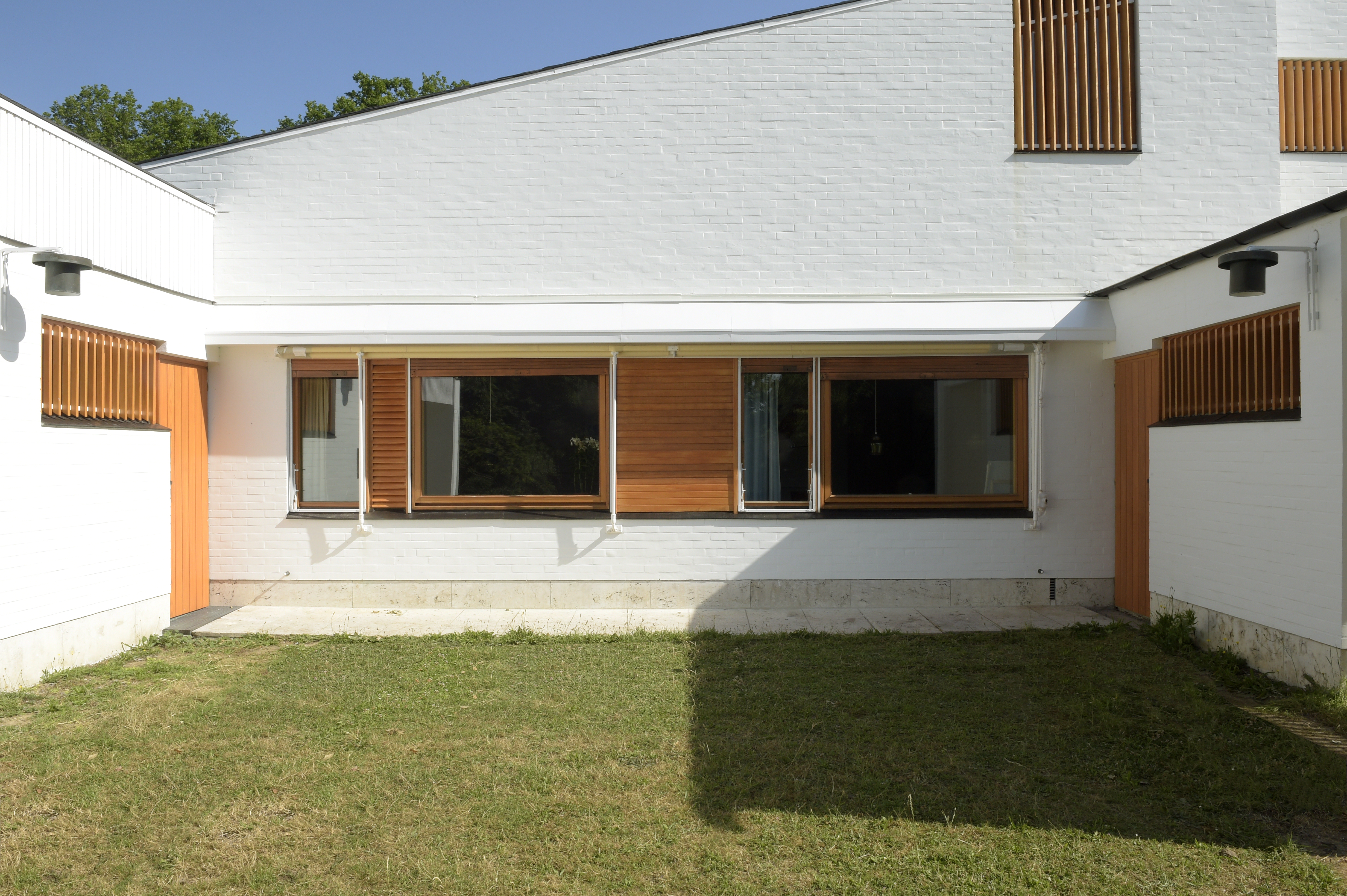 the white, clear, crisp and restored Maison Louis Carre by Alvar Aalto against blue skies