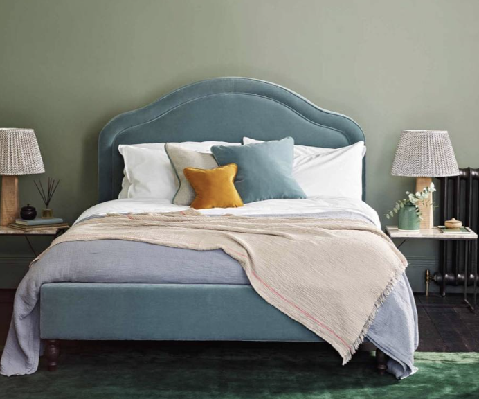 blue bed with large headboard