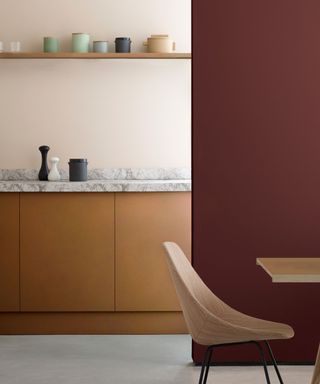 kitchen with tan colored cabinets, marble worktop and peach walls