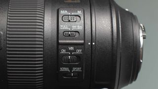 Image shows a side view of the Nikkor AF-S 200-500mm f/5.6E ED VR telezoom lens