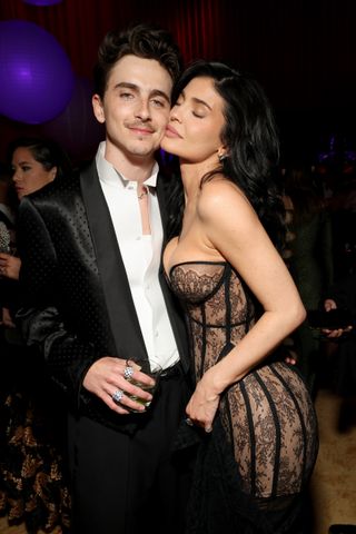 Kylie Jenner stands with Timothee Chalamet inside the 2025 Oscars after party