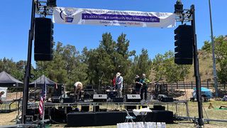 The stage being set up with blue skies in the back drop with HARMAN Professional Solutions at the 2022 American Cancer Society Relay For Life of Santa Clarita Valley.