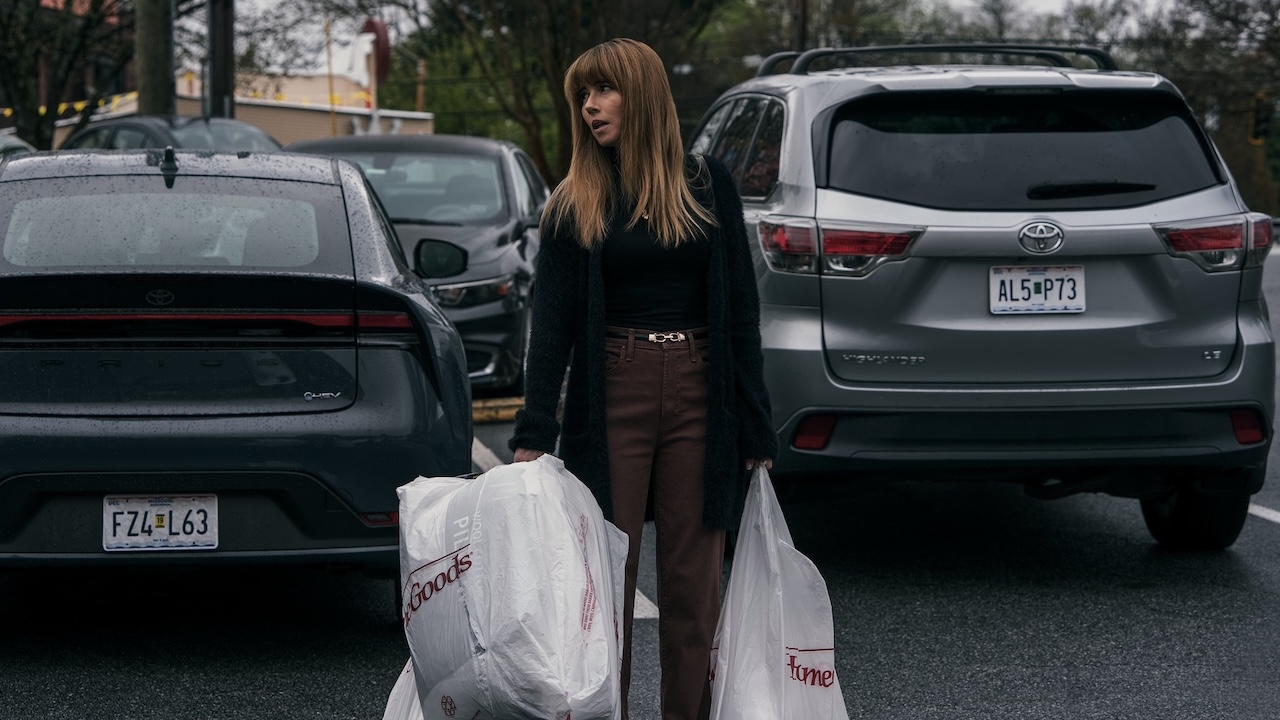 Carol standing in parking lot holding large shopping bags from HomeGoods in DTF St. Louis finale
