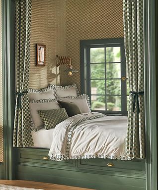 green bed nook with checked curtains and white and green scalloped bedding