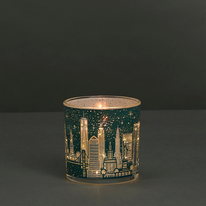 Green M&S Light up candle depicting the New York Skyline