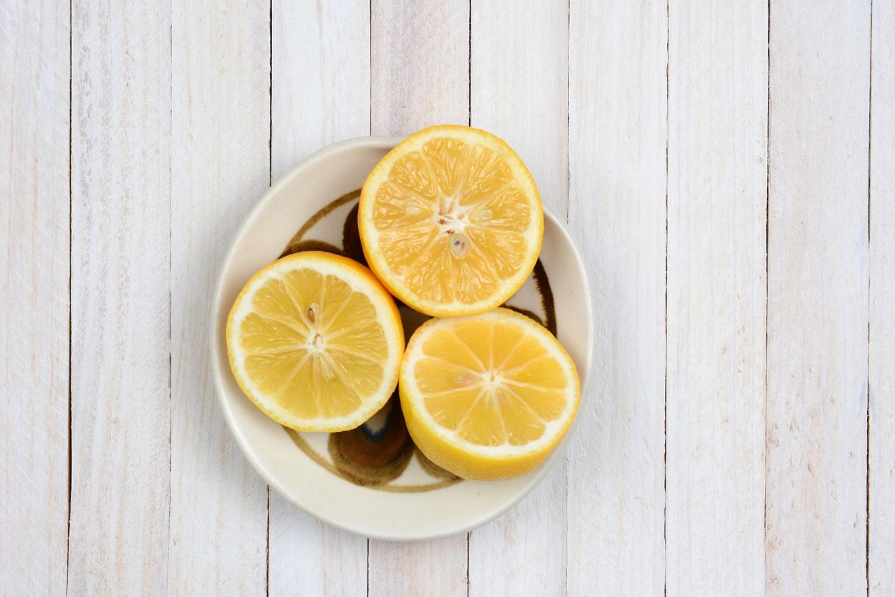 Lemons in a bowl on a wooden table