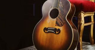 Gibson Murphy Lab Acoustics: the meticulously aged and relic'd guitars are photographed in a dark room.