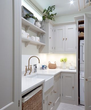 A small laundry room with painted Shaker-style cabinets