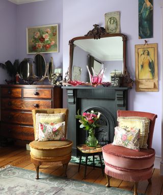 bedroom fireplace with two vintage tub chairs beside