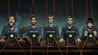 Karnivool posing for a photograph with wires connecting them