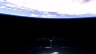 A view of the Earth behind Virgin Galactic's VSS Unity on the Galactic 07 mission.