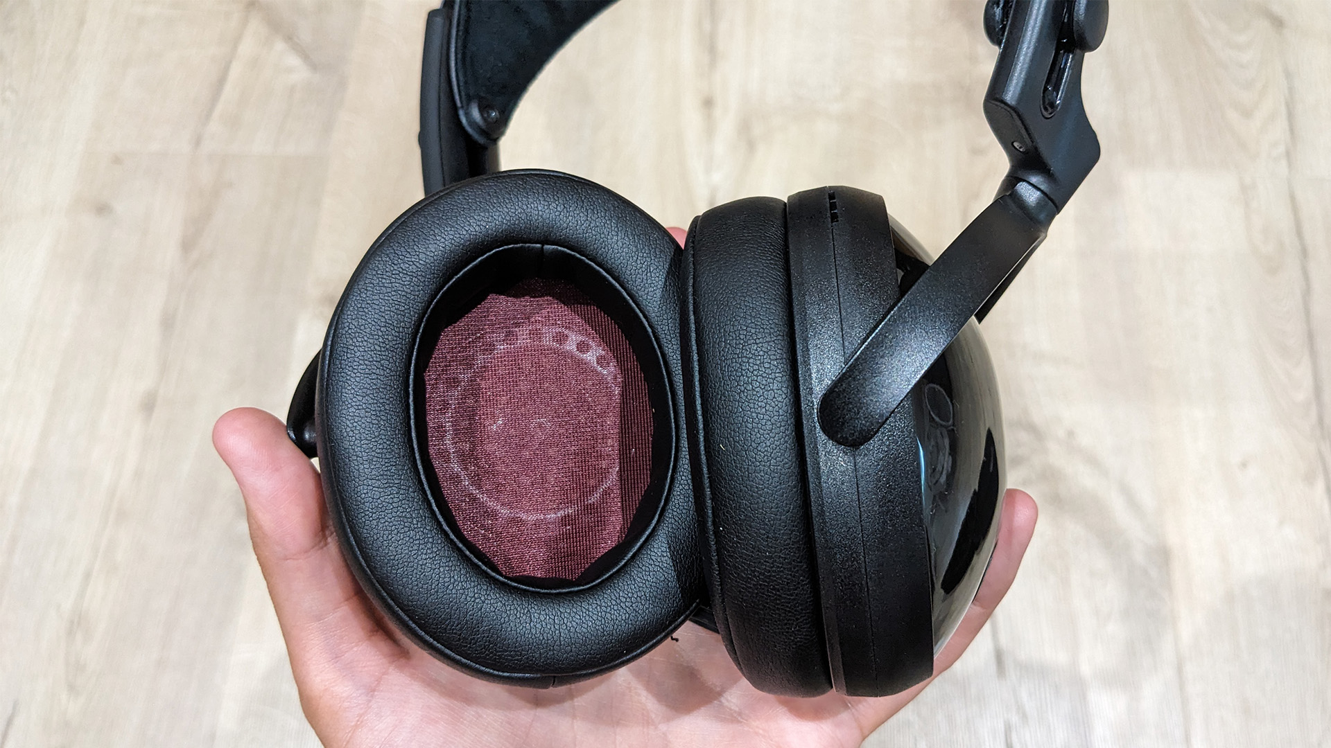 Yamaha YH-C3000 over-ear headphones held in hand, one inner earcup is visible
