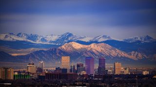 The Denver skyline with the Rocky Mountains behind it