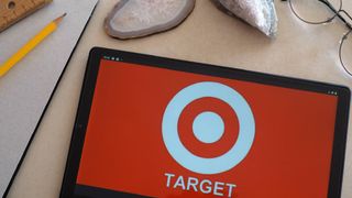 Target logo on a tablet next to a pencil and paper