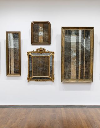gilded mirrors that are striped with bindis