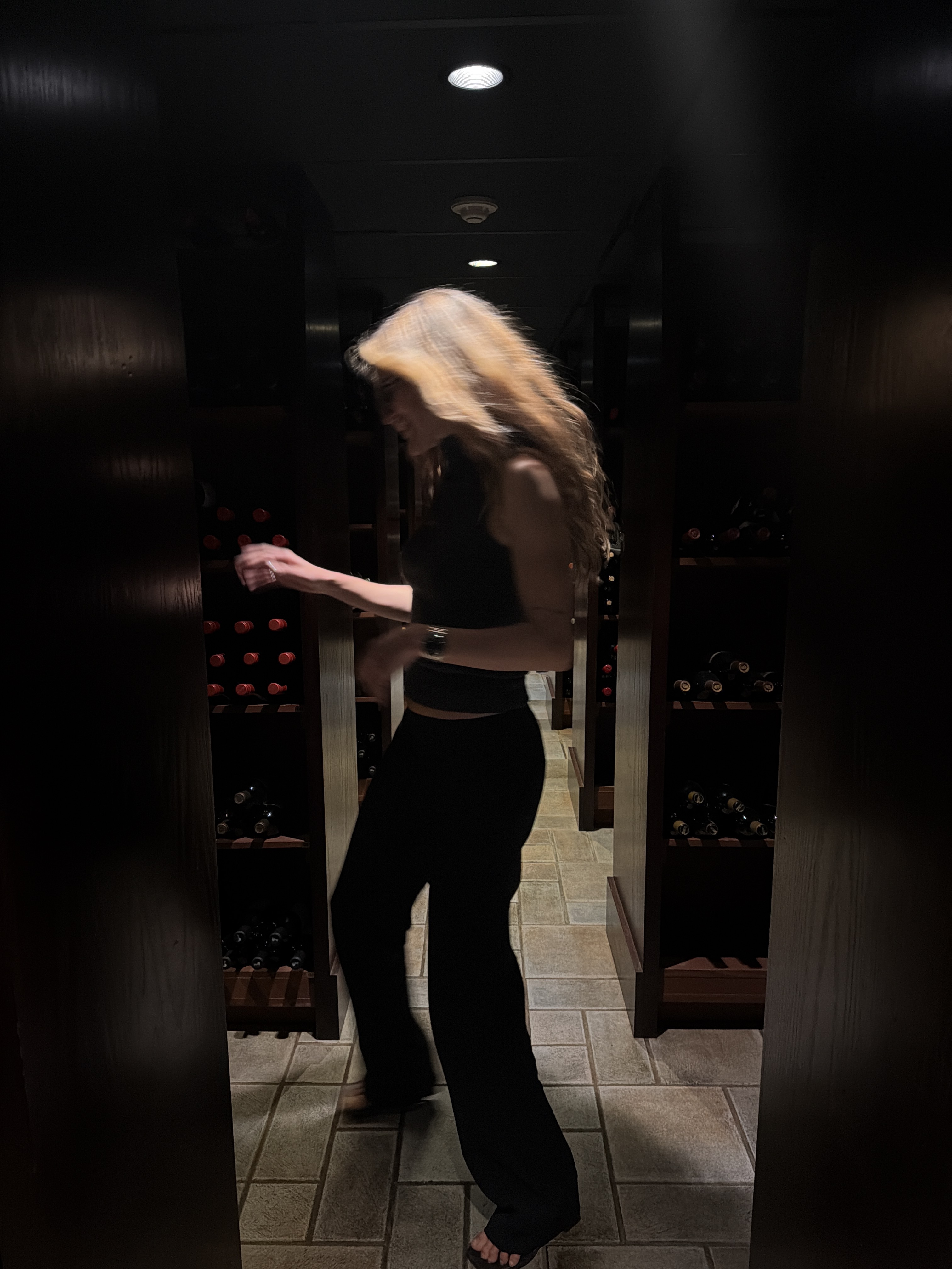 Eliza Huber at St. Elmo Steak House in Indianapolis, IN wearing a sleeveless turtleneck and black trousers.