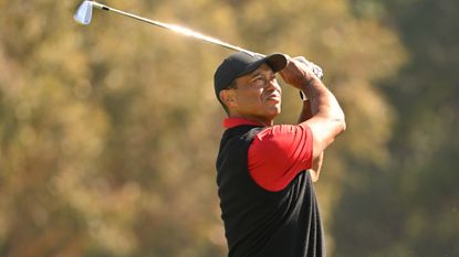 Tiger Woods plays an iron shot