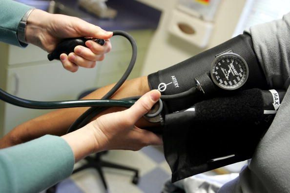 A person has their blood pressure checked.