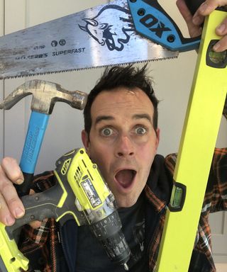 Dom Wood holding saw, spirit level and other tools