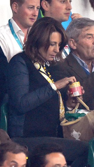 Carole Middleton opens a packet of snacks as she watches the 2015 Rugby World Cup