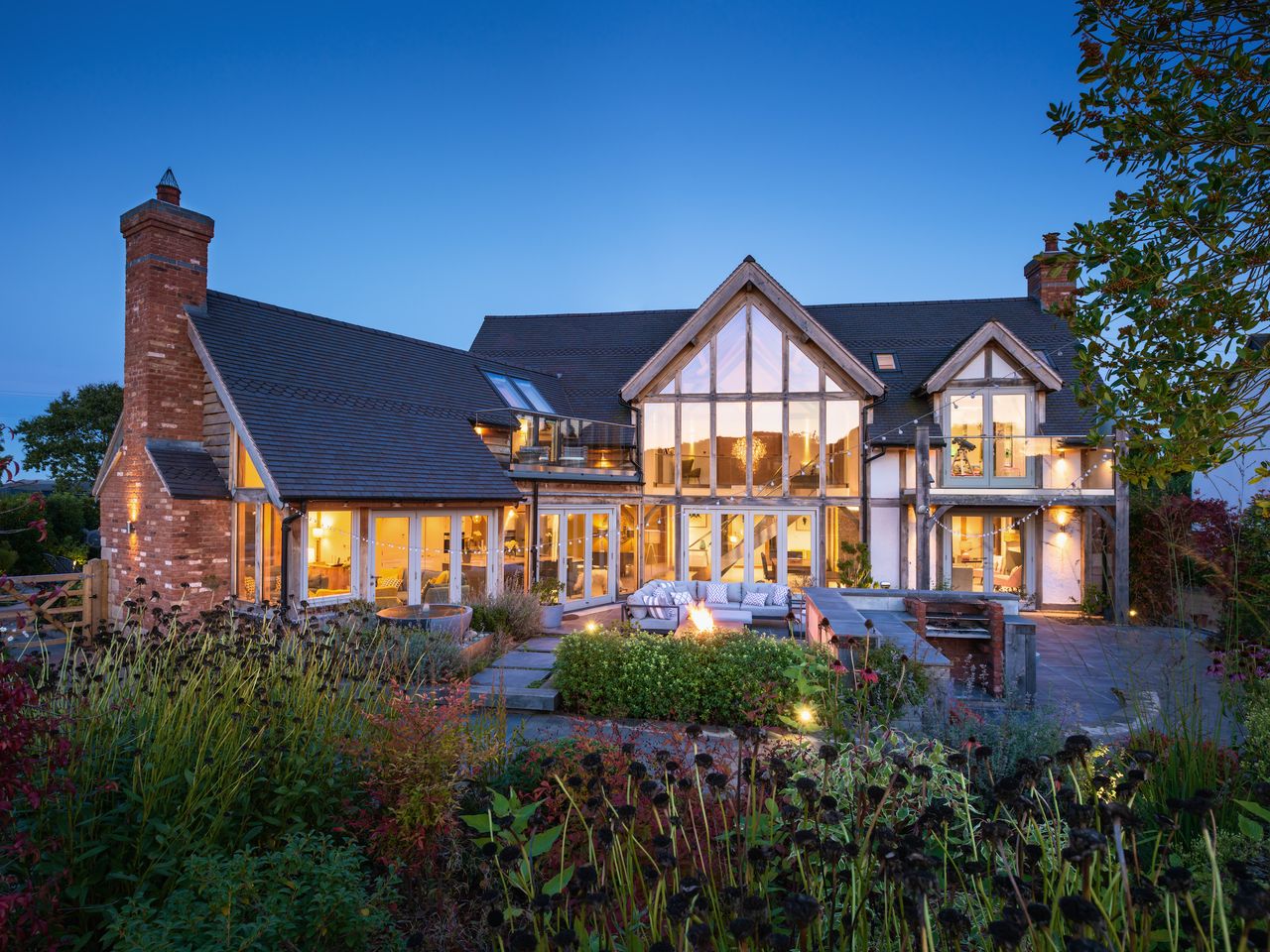 oak frame self build with lots of glass and modern garden