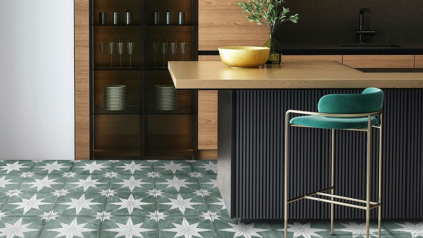 Contemporary kitchen featuring dark wood cabinetry, a fluted black island, and green patterned floor tiles with white star motifs. A teal upholstered bar stool and brass accents add contrast to the warm wood and bold geometric flooring.