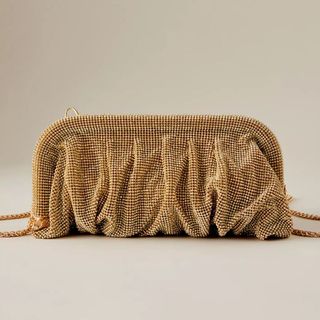 flat lay image of gold clutch bag