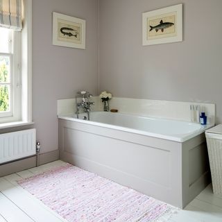 bathtub in bathroom with wall painting