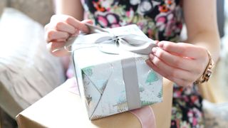 picture of woman unwrapping a present