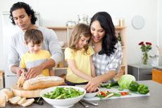 A family prepares dinner in the kitchen