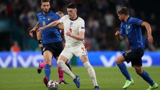 Declan Rice runs the ball out of midfield as England play Italy