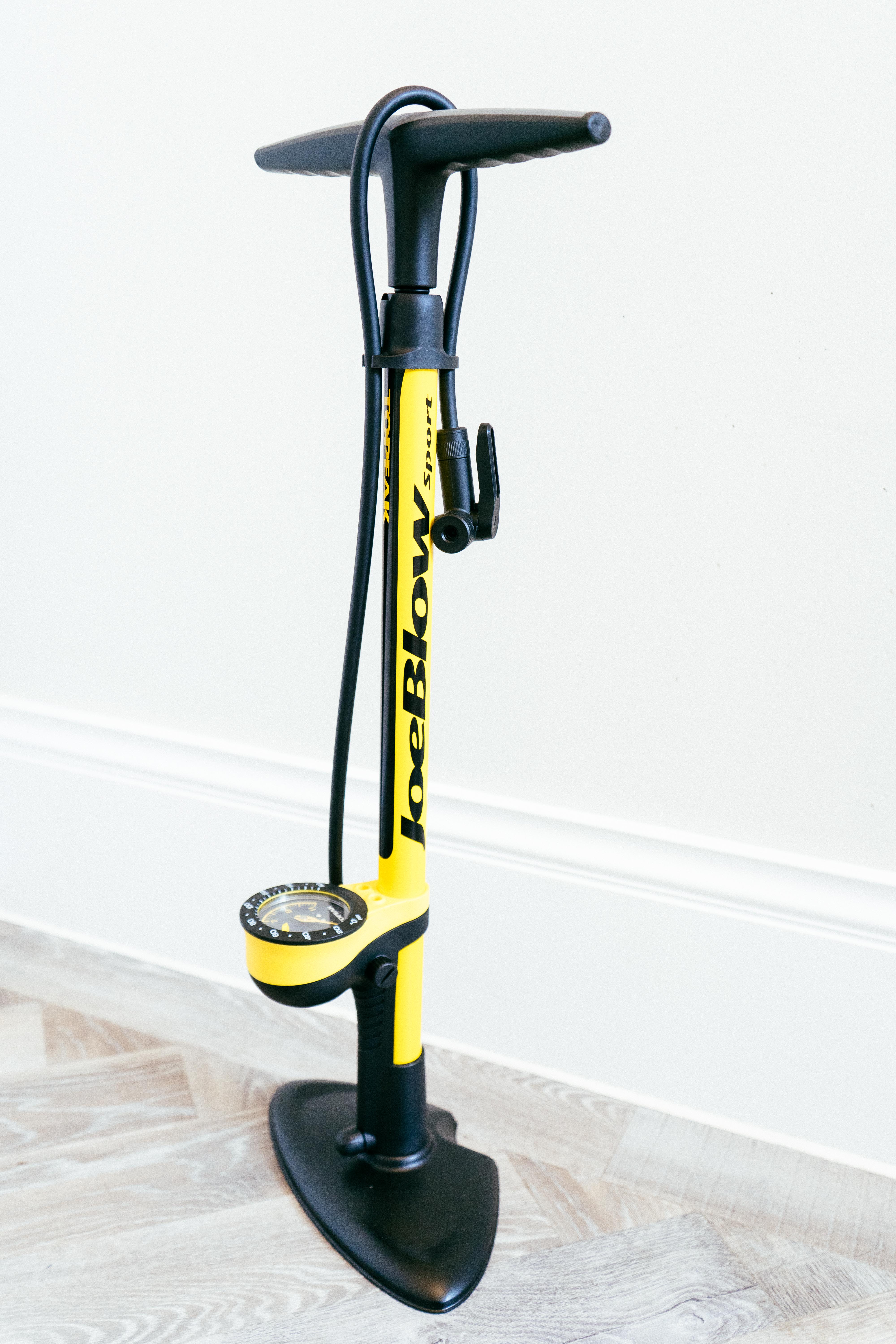 A yellow bike floor pump