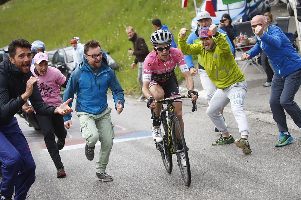 Fans run alongside Simon Yates (Mitchelton-Scott) as he solos to victory at stage 15 at the Giro d'Italia