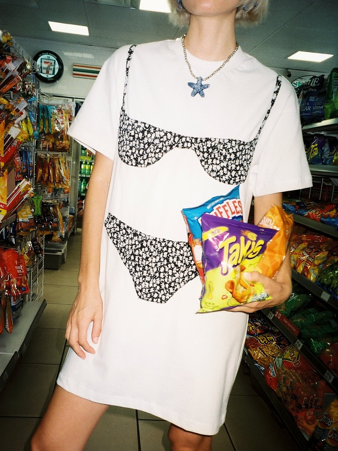 Model wears swimsuit dress from Nikki Chasin.