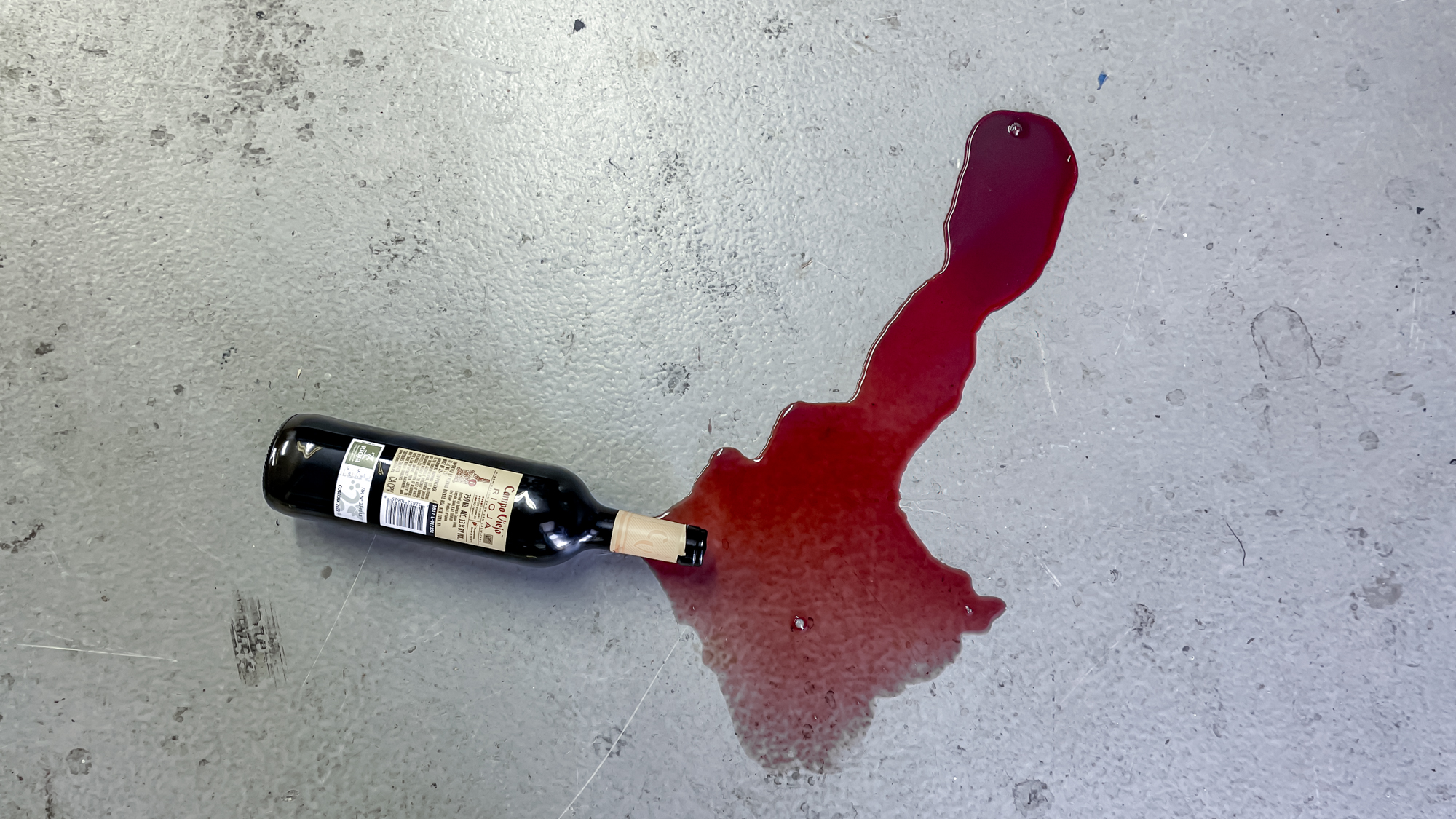 Dreame Aero Pro Wet Dry Vacuum mopping up wine on a concrete floor