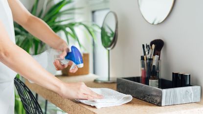Woman cleaning surface with cloth