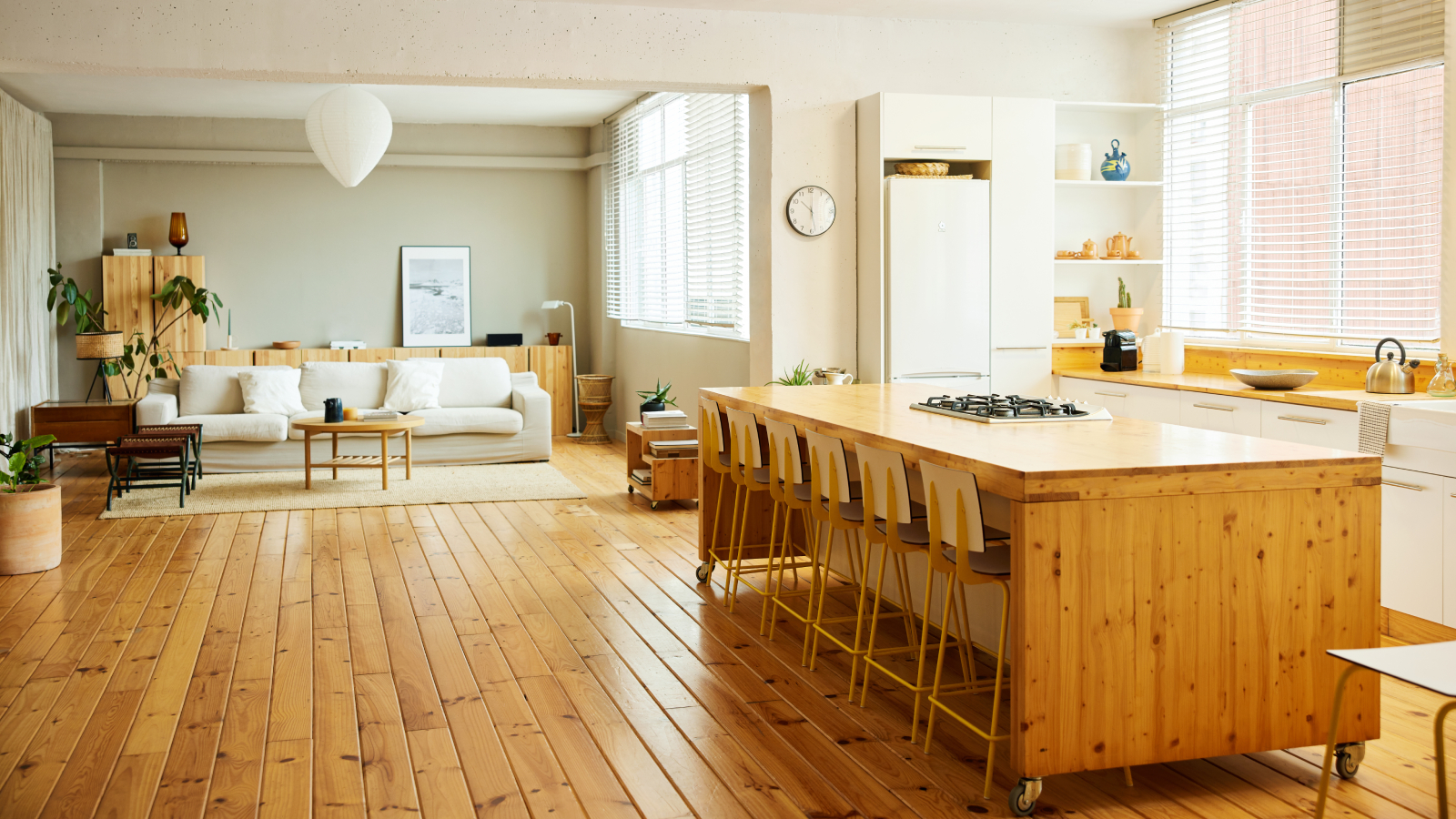 wooden flooring in kitchen with wooden island and open plan layout