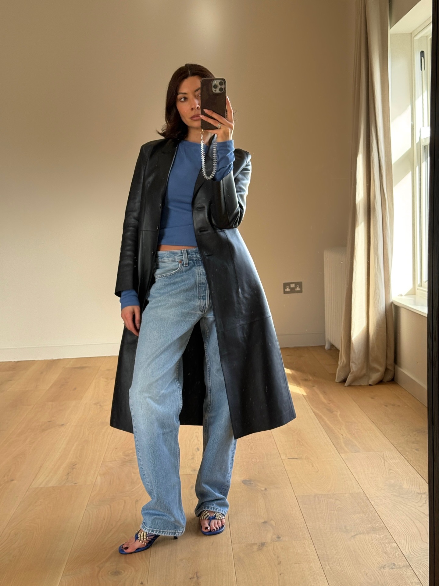 Woman wearing wide leg jeans with spring 2026 shoe trend.