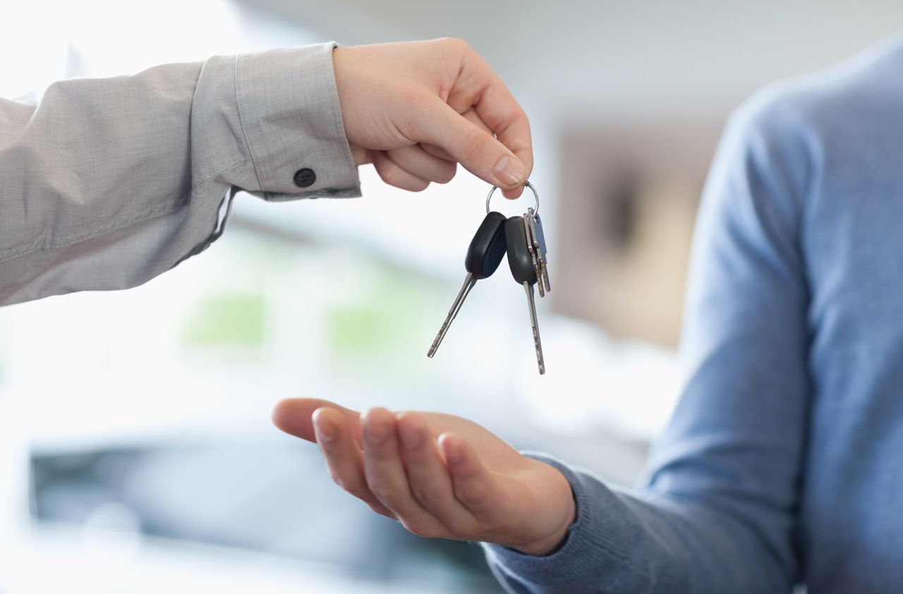 Man giving keys to someone