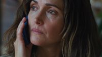Rose Byrne's character Linda answers the phone and looks off in the distance.